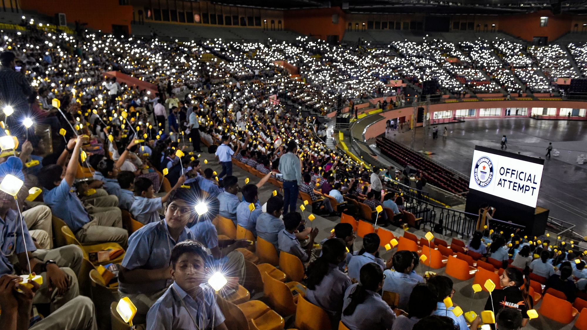 Thousands of students gather for Global Student Solar Assembly  at Indira Gandhi Indoor Stadium in New Delhi. Students lit solar lamps in unison in an attempt for Guinness world record attempt.