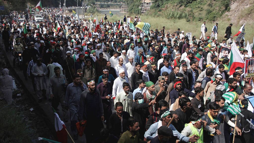 Supporters of Jammu Kashmir Liberation Front march towards the LoC on Saturday, 5 October.