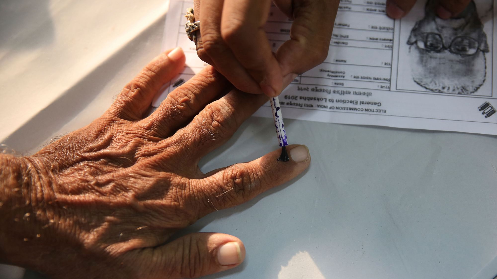 File photo of an  elderly citizen getting ink mark on his finger prior to voting. Used for representation.