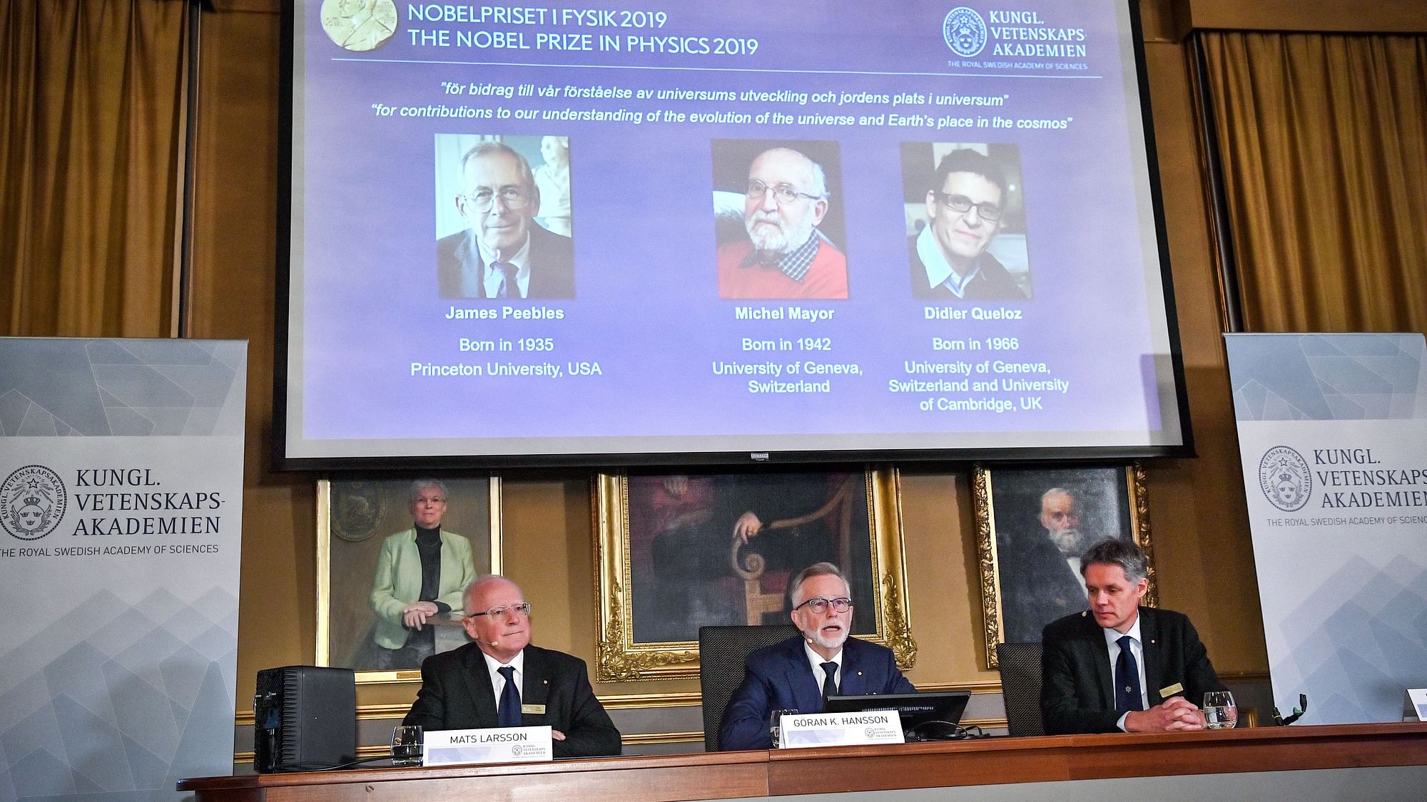 Goran K Hansson, secretary general of the Royal Swedish Academy of Sciences, and academy members Mats Larsson and Ulf Danielsson, announce the winners of the 2019 Nobel Prize in Physics.&nbsp;
