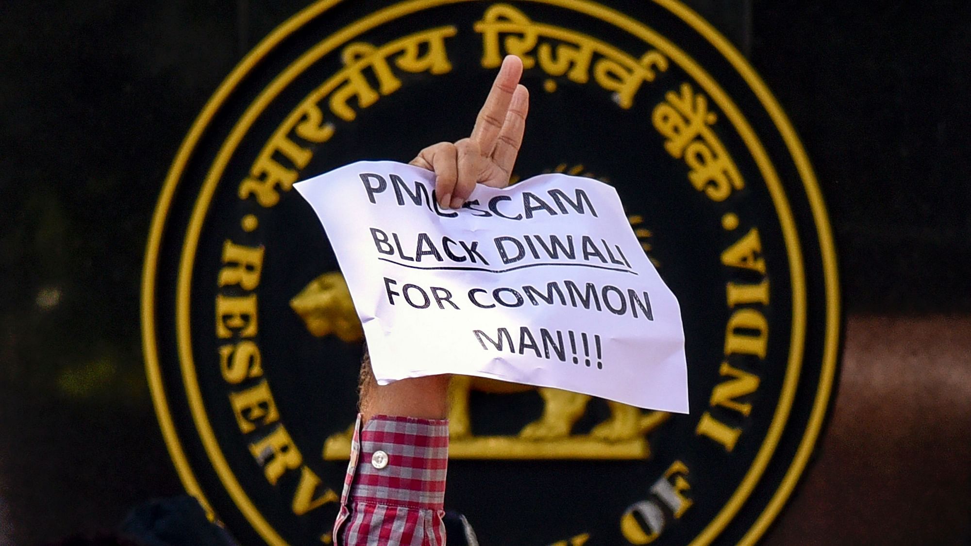  A depositor of Punjab and Maharashtra Cooperative (PMC) bank displays a placard during a protest over the banks crisis, outside the Reserve Bank of India building, in Mumbai. Image used for representation.