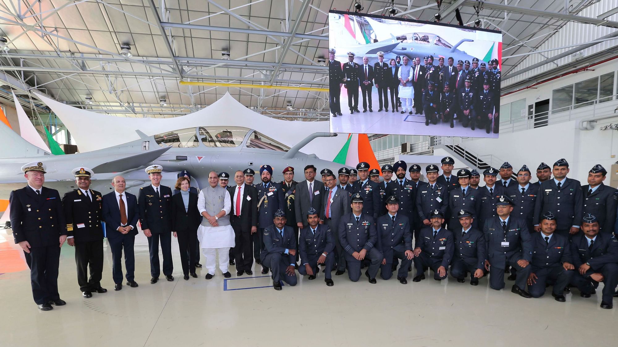 Defense Minster Rajnath Singh poses with Indian and French military officials at the Dassault Aviation plant in Merignac, near Bordeaux, southwestern France.