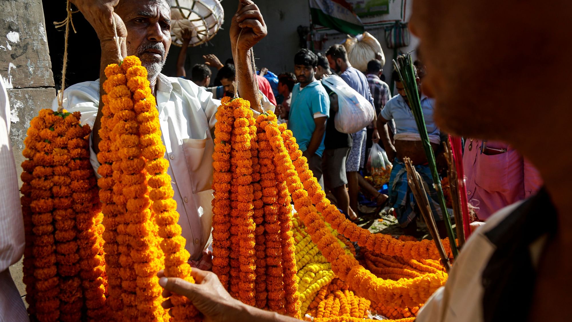 A vendor sells marigold flower garlands in Kolkata.&nbsp;