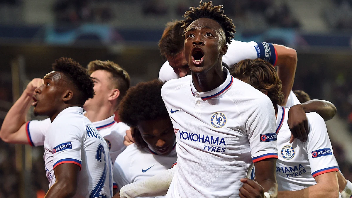 Chelsea’s Willian, center, is mobbed by his teammates including Tammy Abraham, right, after scoring a goal during the group H Champions League soccer match.