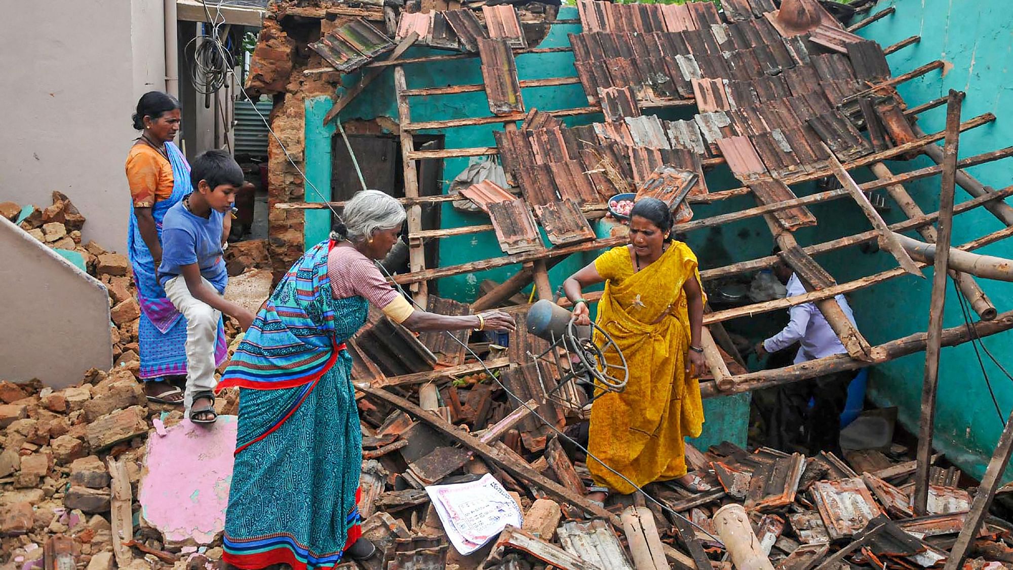 Residents salvage their household items after a house collapsed following rains, in Chikmagalur district of Karnataka.