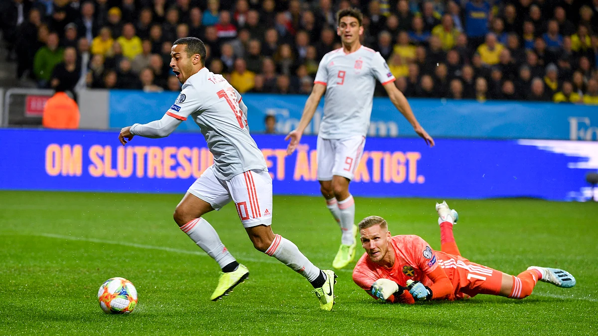 Spain’s Thiago Alcantara (L) dribbles the ball past Sweden’s goalkeeper Robin Olsen during the Euro 2020 Group F qualification soccer match between Sweden and Spain at Friends Arena in Solna, Stockholm, Sweden, on Oct. 15, 2019. 