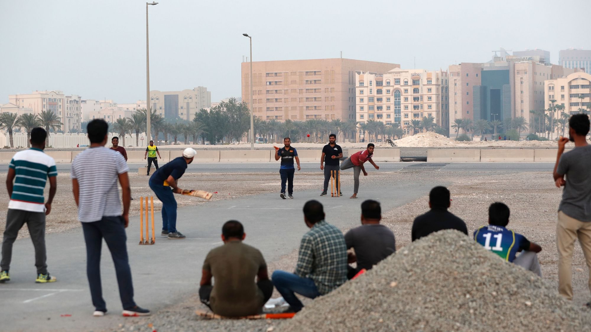 People play cricket on a patch of wasteland in Doha, Qatar, Friday, Oct. 4, 2019. The most played sport in Qatar is nowhere near the country’s glitzy, air-conditioned stadiums.&nbsp;