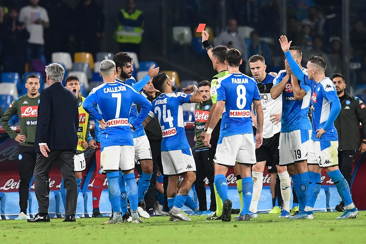 Referee Piero Giacomelli shows a red card to Napoli head coach Carlo Ancelotti, left, during the Italian Serie A soccer match.