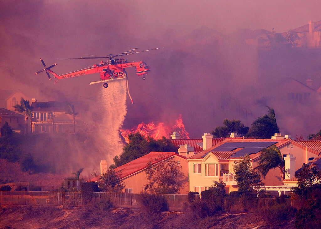 An aggressive wildfire in Southern California seared its way through, destroying more than a dozen homes.