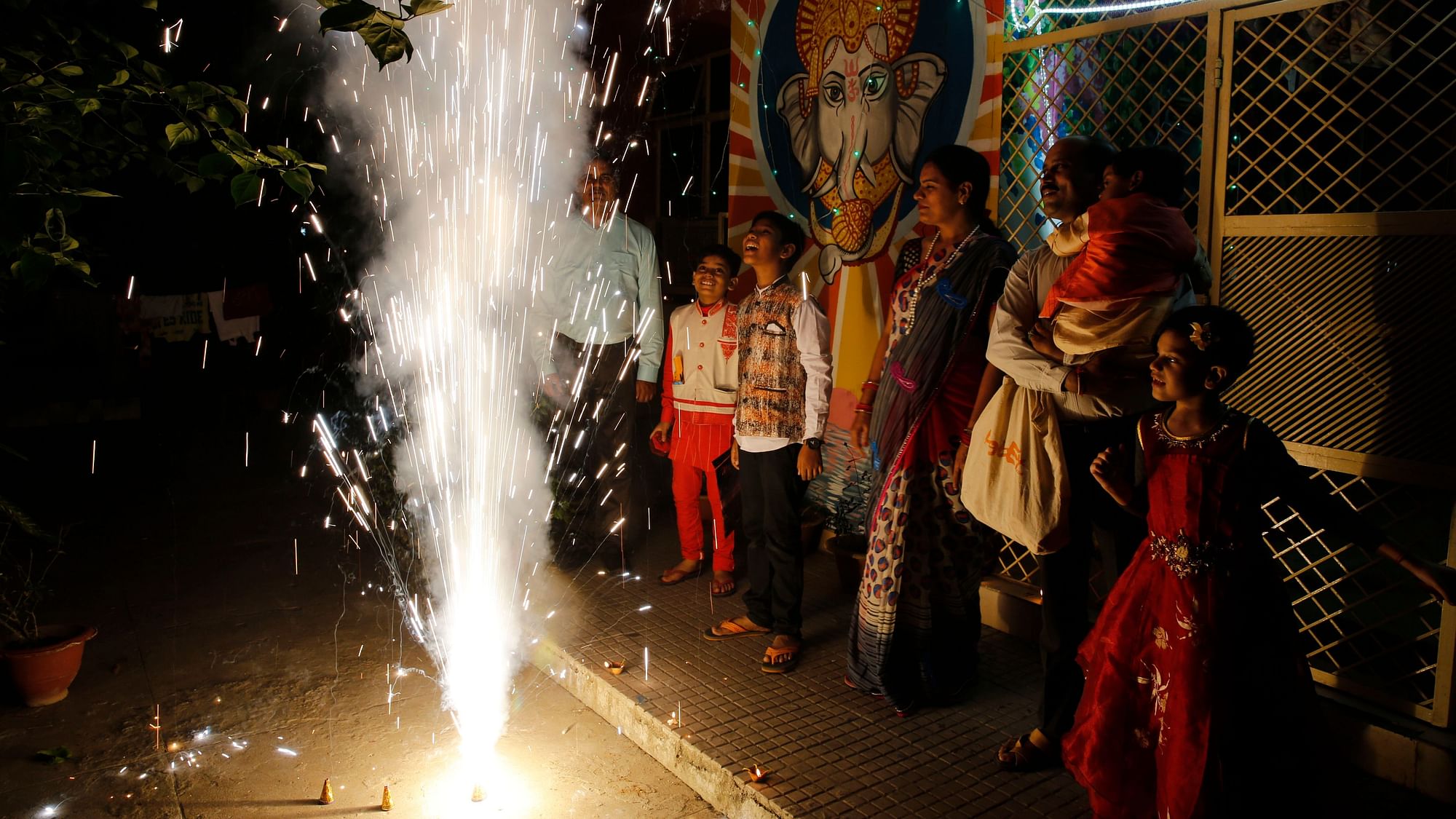 A family bursts firecrackers as part of Diwali celebrations. (File picture)