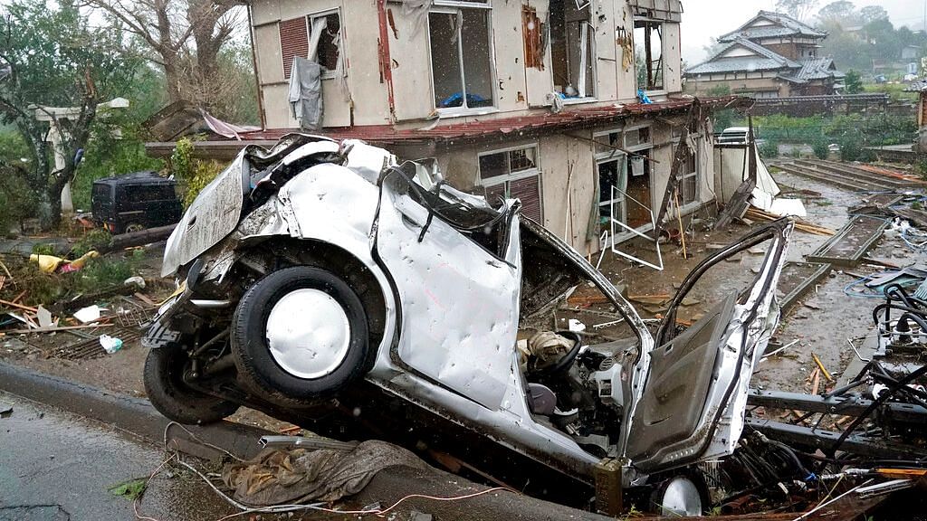 A damaged car lies on the ground following a strong wind in Ichihara, Chiba, near Tokyo Saturday, 12 October , 2019.