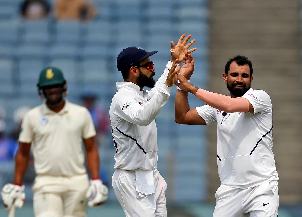 Mohd Shami and Virat Kohli during the second Test between India and South Africa at Pune.