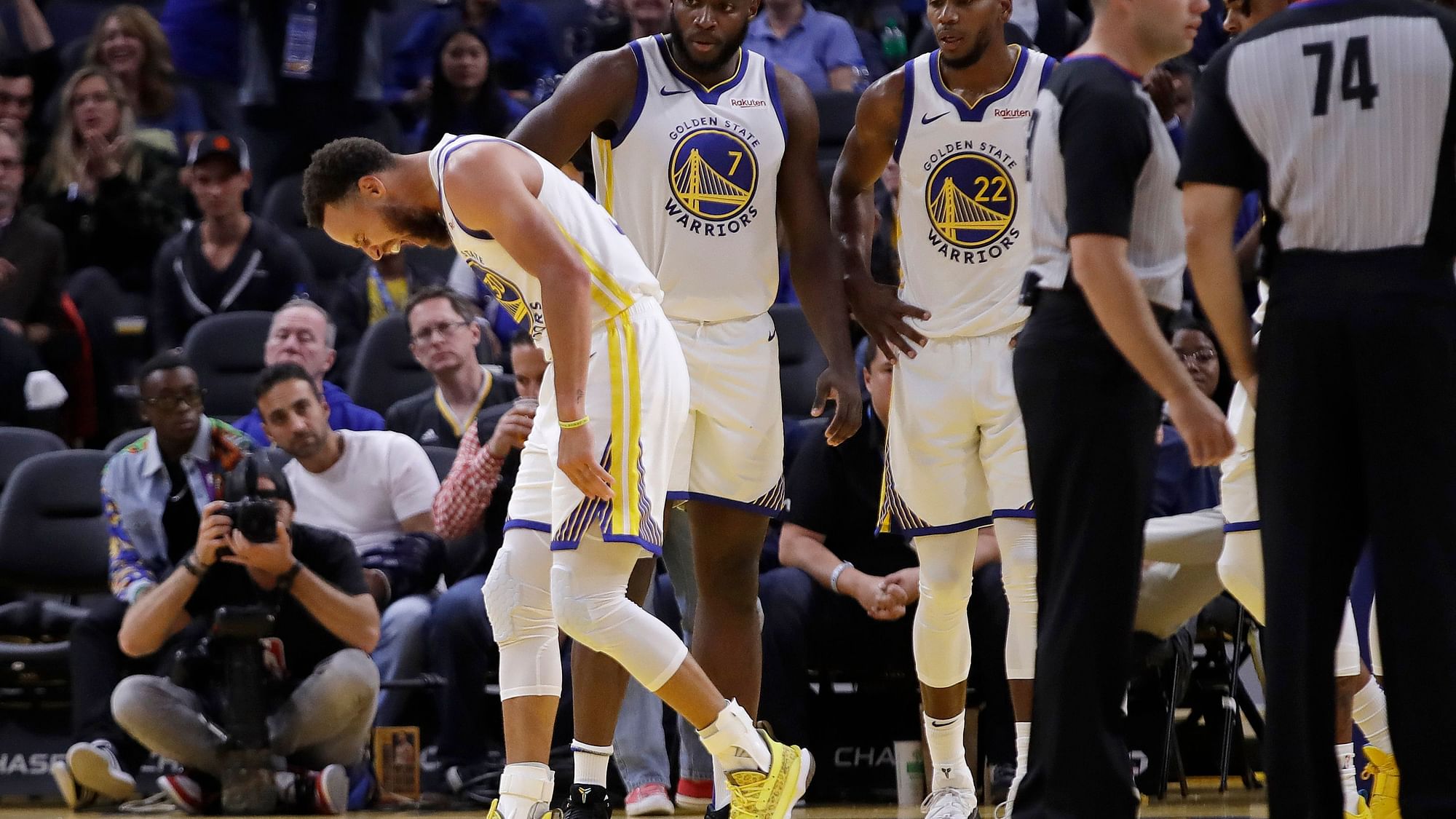 Golden State Warriors’ Stephen Curry, left, grimaces in pain after Phoenix Suns’ Aron Baynes fell on him during the second half of an NBA basketball game Wednesday, Oct. 30, 2019, in San Francisco.