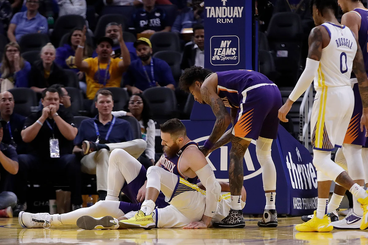 Phoenix Suns’ Aron Baynes, left, gets up after falling on Golden State Warriors’ Stephen Curry during the second half of an NBA basketball game Wednesday, Oct. 30, 2019, in San Francisco. Curry left the game with injury.