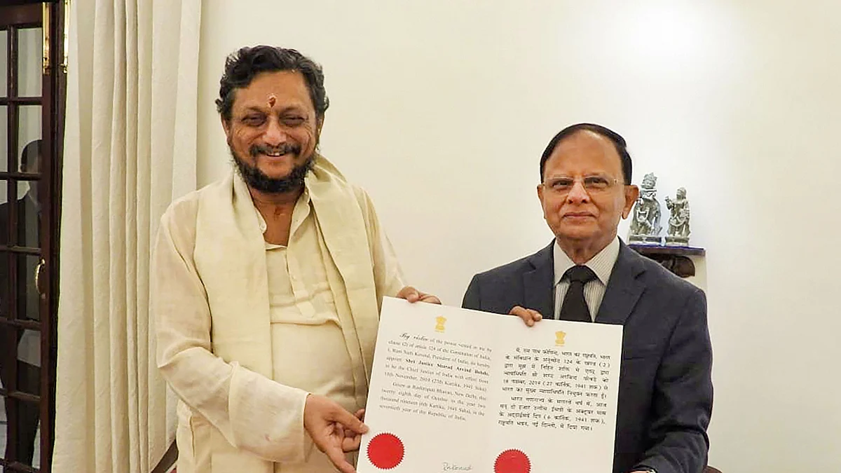 Justice SA Bobde (left) is being present the warrant of appointment to Chief Justice of India-designate by Principal Secretary to PM, PK Mishra.