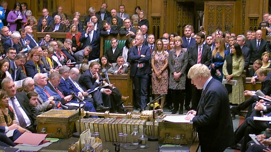 Britain’s Prime Minister Boris Johnson delivers a statement to lawmakers inside a crowded House of Commons in London, Saturday 19 October, 2019