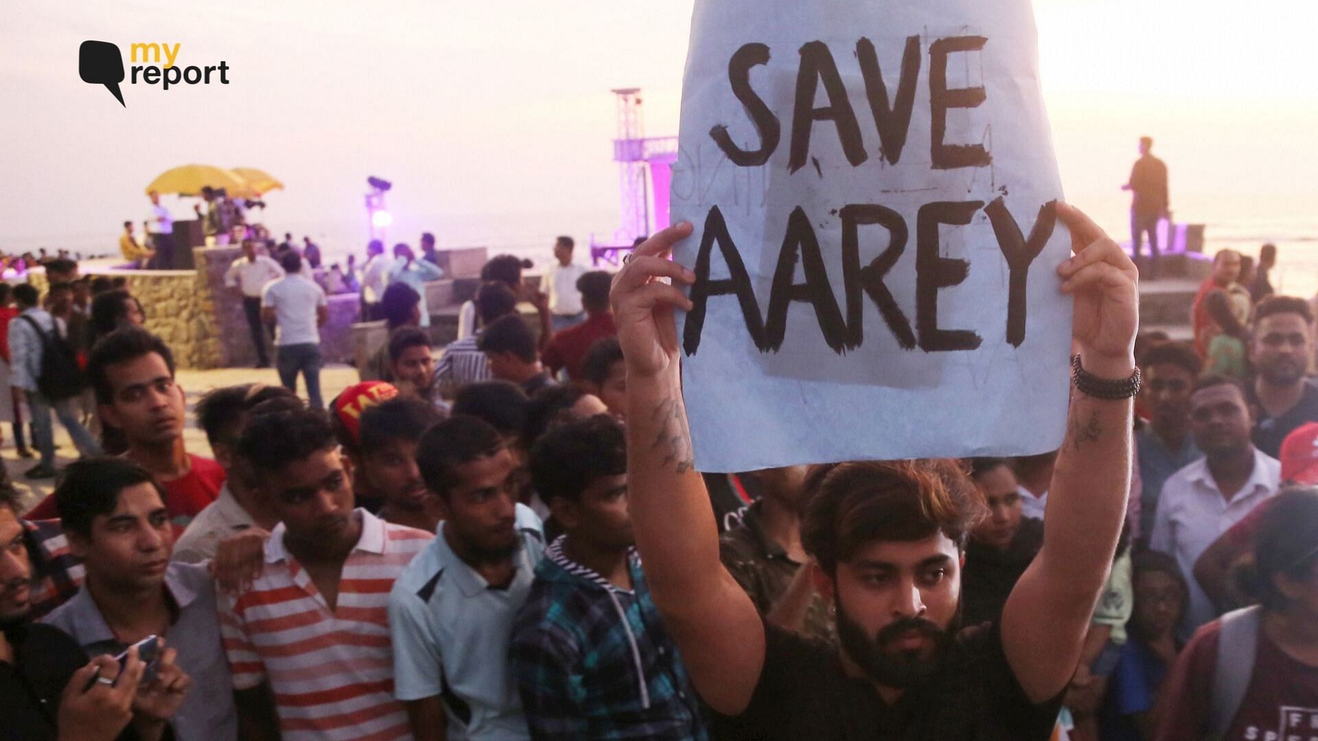  An activist holds a placard during a protest against cutting down of trees at Mumbai’s Aarey Colony.