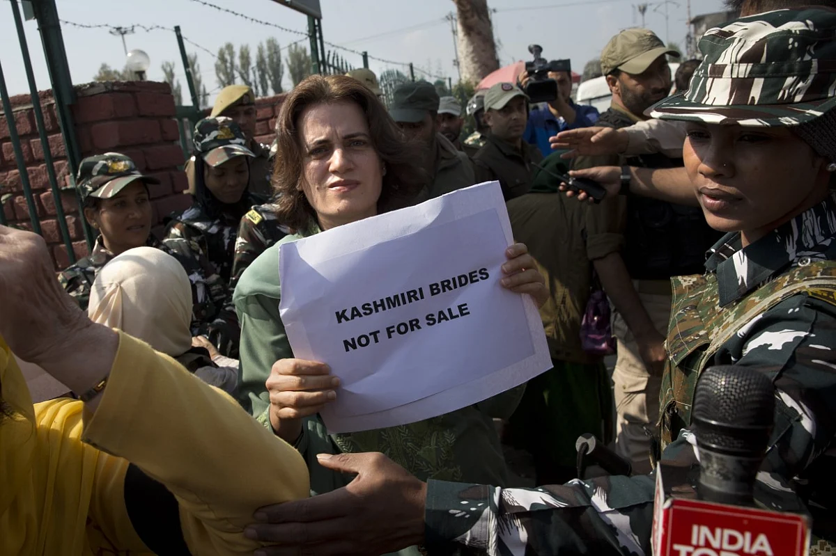 Safia Abdullah, daughter of Jammu and Kashmir National Conference leader Farooq Abdullah, holds a placard during a protest in Srinagar.