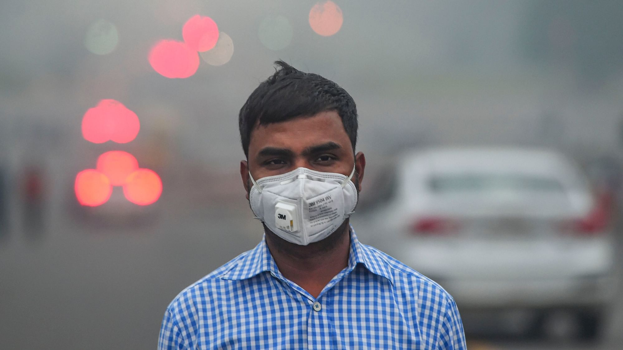 A man in Delhi walks with a mask.