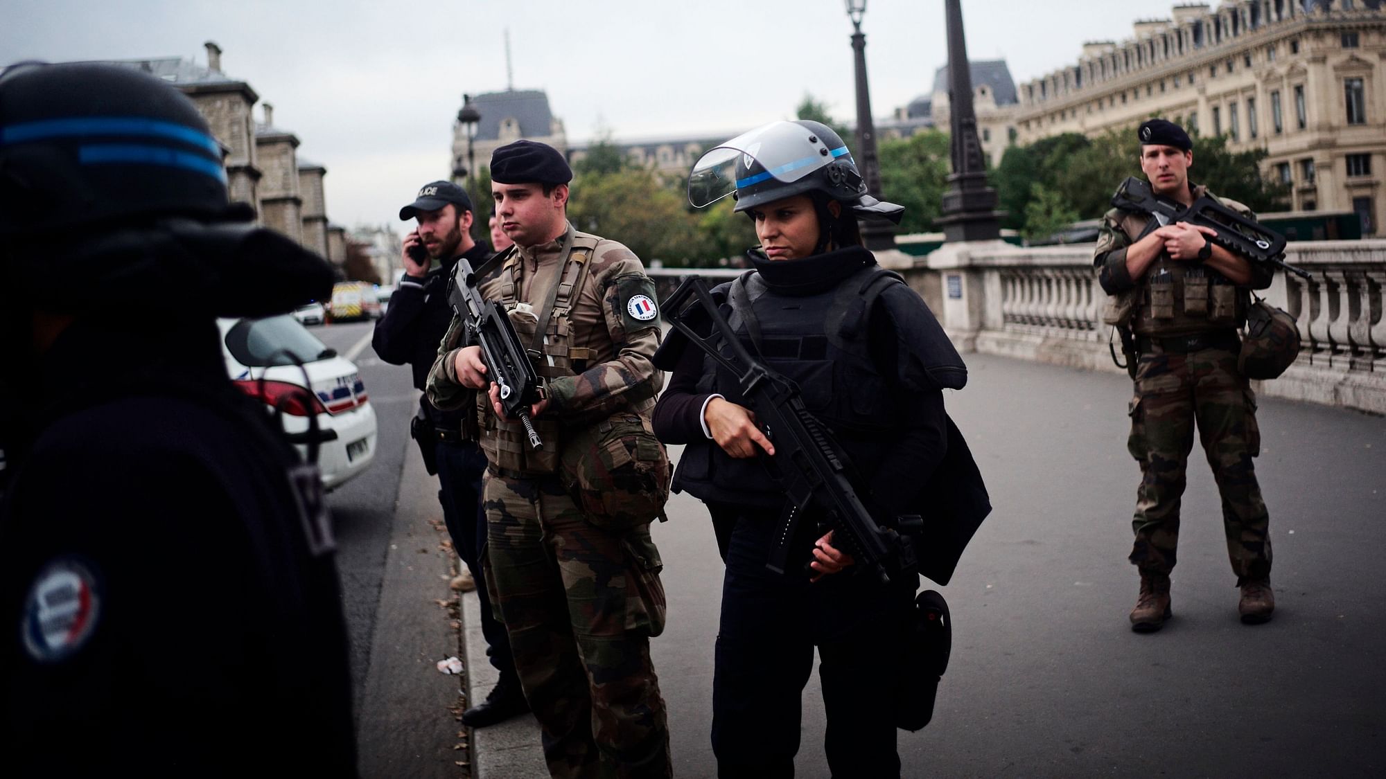 Armed police officers and soldiers patrol after an incident at the police headquarters in Paris.