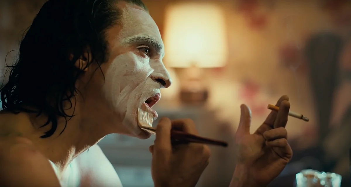 Arthur Fleck puts on his Joker makeup.