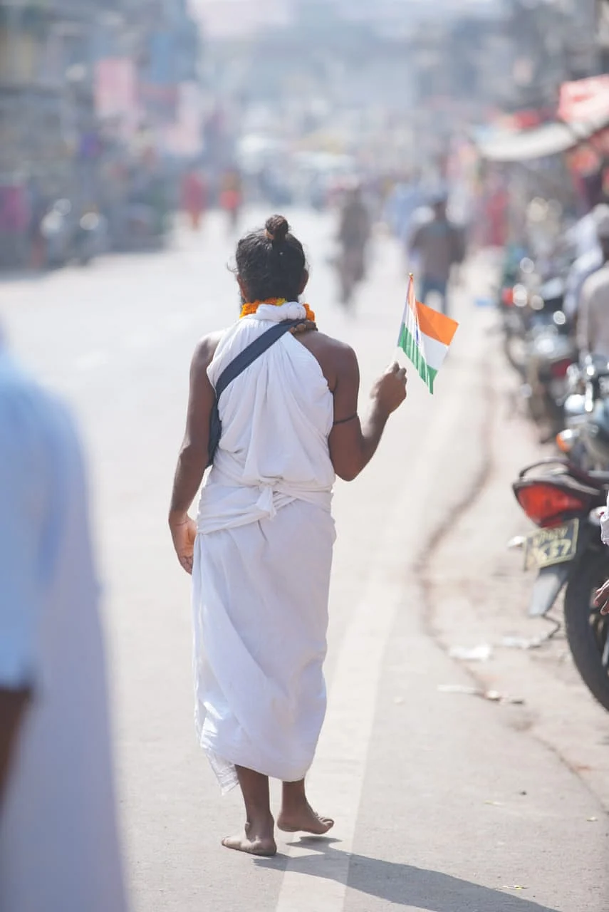 A man waving the Indian flag and chanting the name of Ram in Ayodhya.