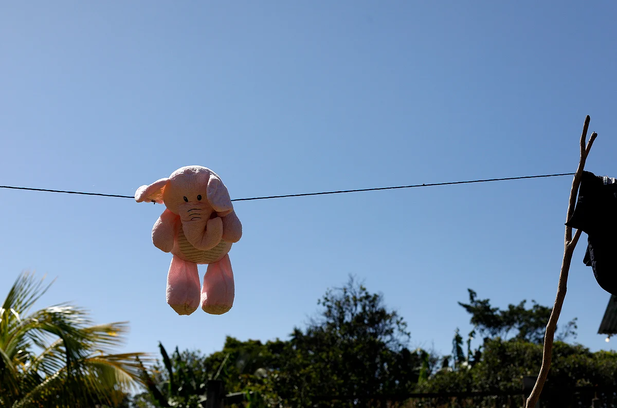 This 23 August 2019, photo shows a stuffed animal hanging to dry at the Comayagua, Honduran home of a 3-year-old who was separated from her father when they tried to seek asylum at the US southern border. She was sexually abused in US foster care, according to court records. She was later deported and arrived back in Honduras withdrawn, anxious and angry.