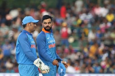 Virat Kohli and MS Dhoni in conversation during a match.&nbsp;