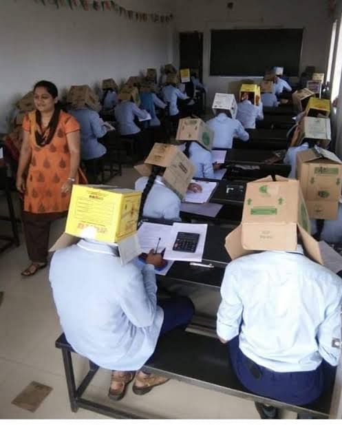 Students were seen wearing cardboard boxes atop their heads to prevent them from cheating. Quite creative, eh?