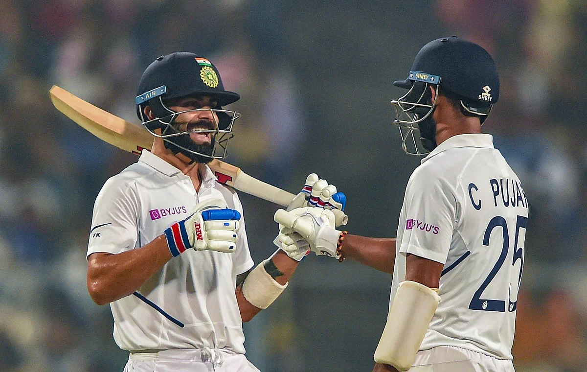 Indian Skipper Virat Kohli and teammate Cheteswar Pujara celebrate their partnership on Day 1 of the 1st pink-ball day-night cricket Test match between India and Bangladesh, at Eden Gardens in Kolkata.