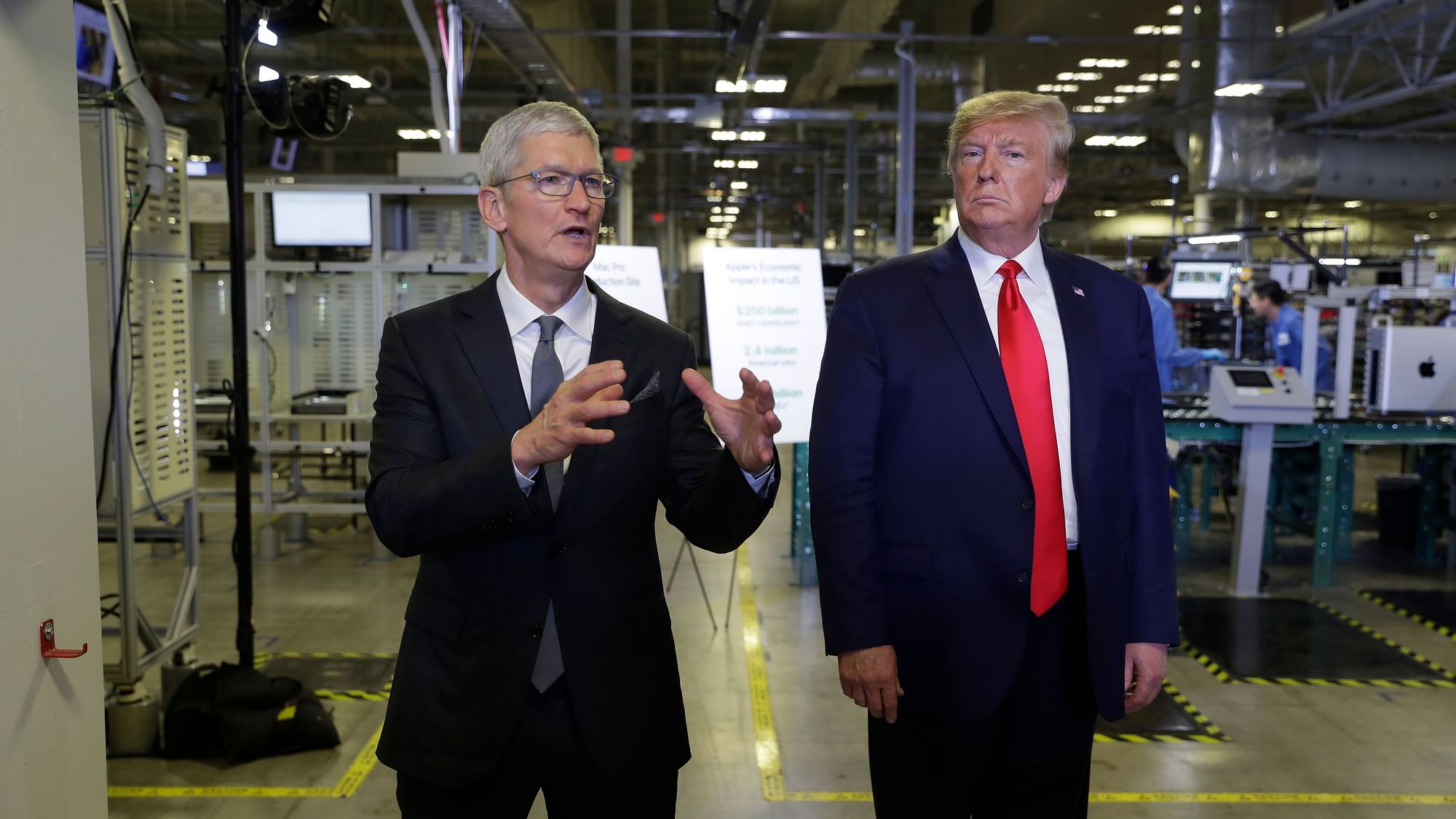 Apple CEO Tim Cook and President Donald Trump speak during a tour of an Apple manufacturing plant in Austin.