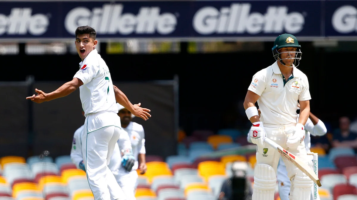 Pakistan’s Naseem Shah, left, celebrates the wicket of Australia’s David Warner, right with bat, before the decision was overturned due to a no ball called during their cricket test match in Brisbane, Australia, Friday, Nov. 22, 2019. 