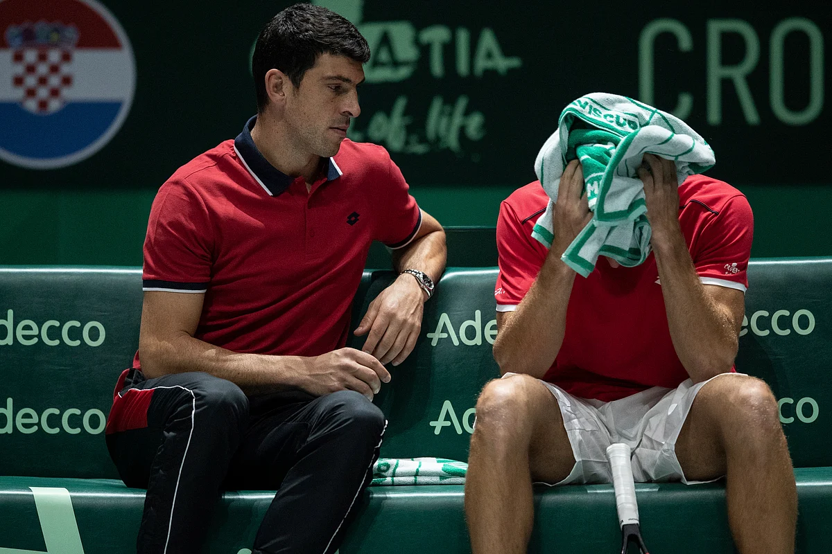 Croatia’s team’s captain Franko Skugor, left, talks with teammate Borna Gojo during their Davis Cup tennis match against Russia’s Andrey Rublev in Madrid, Spain.