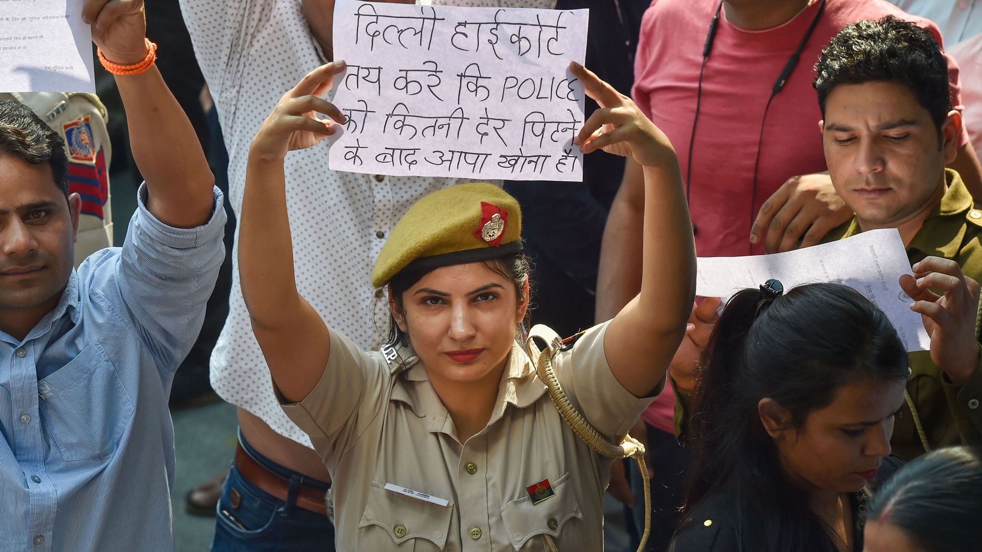 A Delhi Police woman displayed a placard during a protest against the alleged violence against them by lawyers, on Tuesday, 5 November. Image for representation.