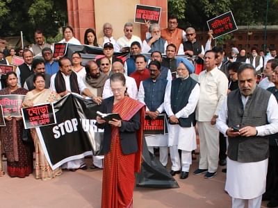New Delhi: Congress president Sonia Gandhi reads the preamble of Constitution at Ambedkar statue in Parliament House on Constitution Day as opposition parties protest on Nov. 26, 2019. (Photo: Amlan Paliwal /IANS)