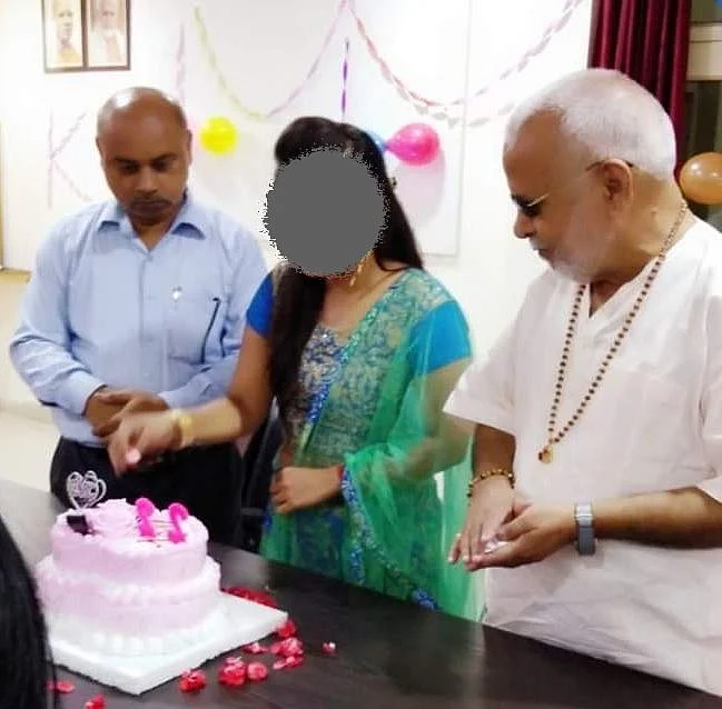 The complainant was photographed during her 22nd birthday celebrations at college. Chinmayanand is to her left and the college principal to her right.
