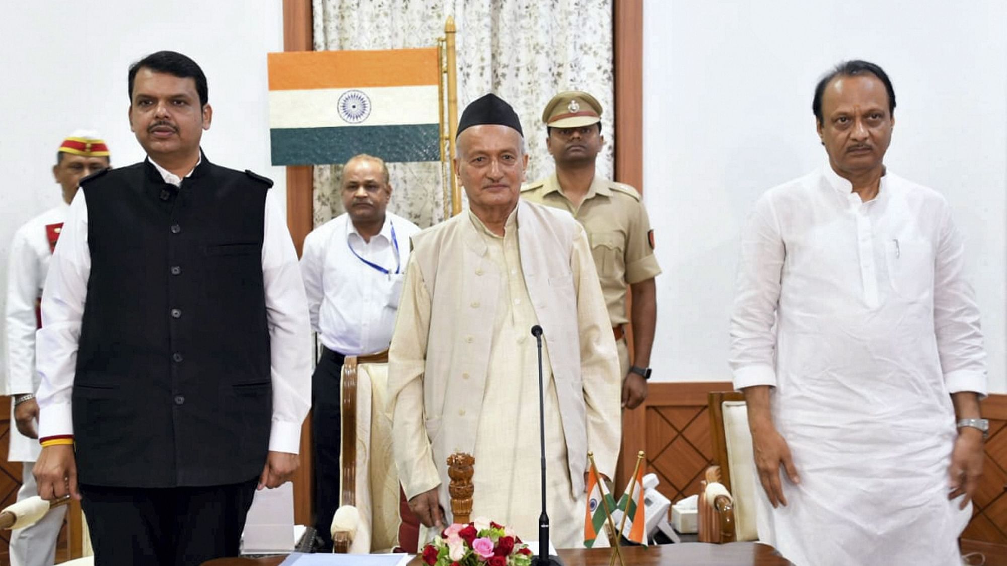 Maharashtra Governor  flanked by newly-appointed Chief Minister of Maharashtra Devendra Fadnavis and his Deputy CM Ajit Pawar, during the oath-taking ceremony,&nbsp;