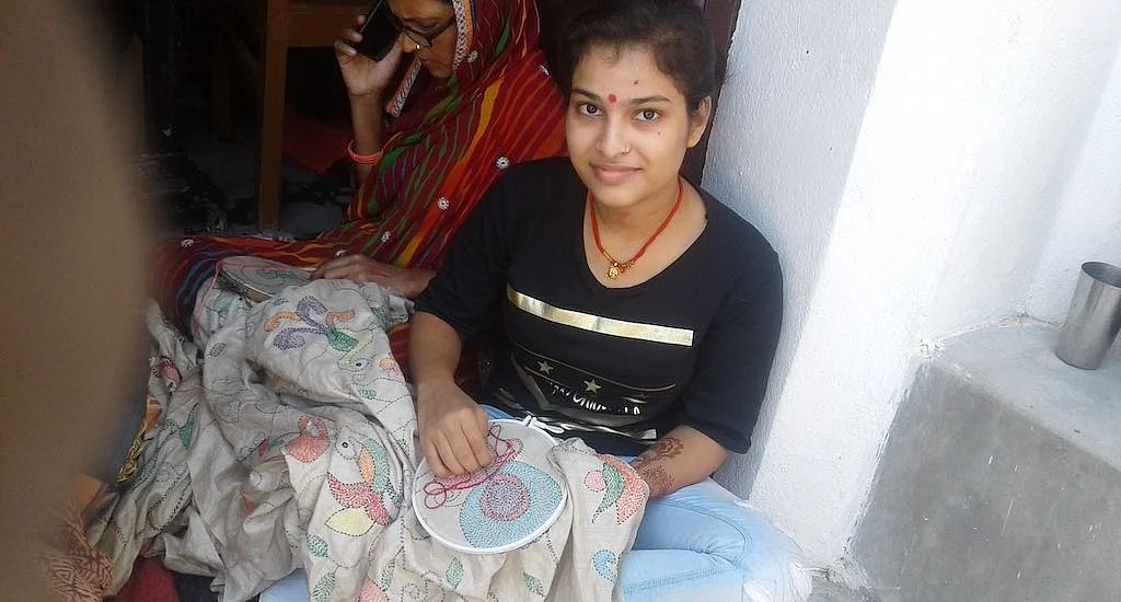 Enamored by the intricate craft, part-time students like Diksha Kumari embroider with their family members