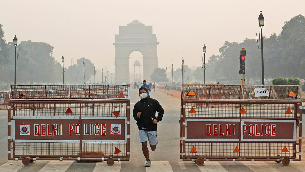 A jogger wears a pollution mask early morning amidst light smog in New Delhi. The national capital’s air quality dropped to the season’s worst on the morning after Diwali. 