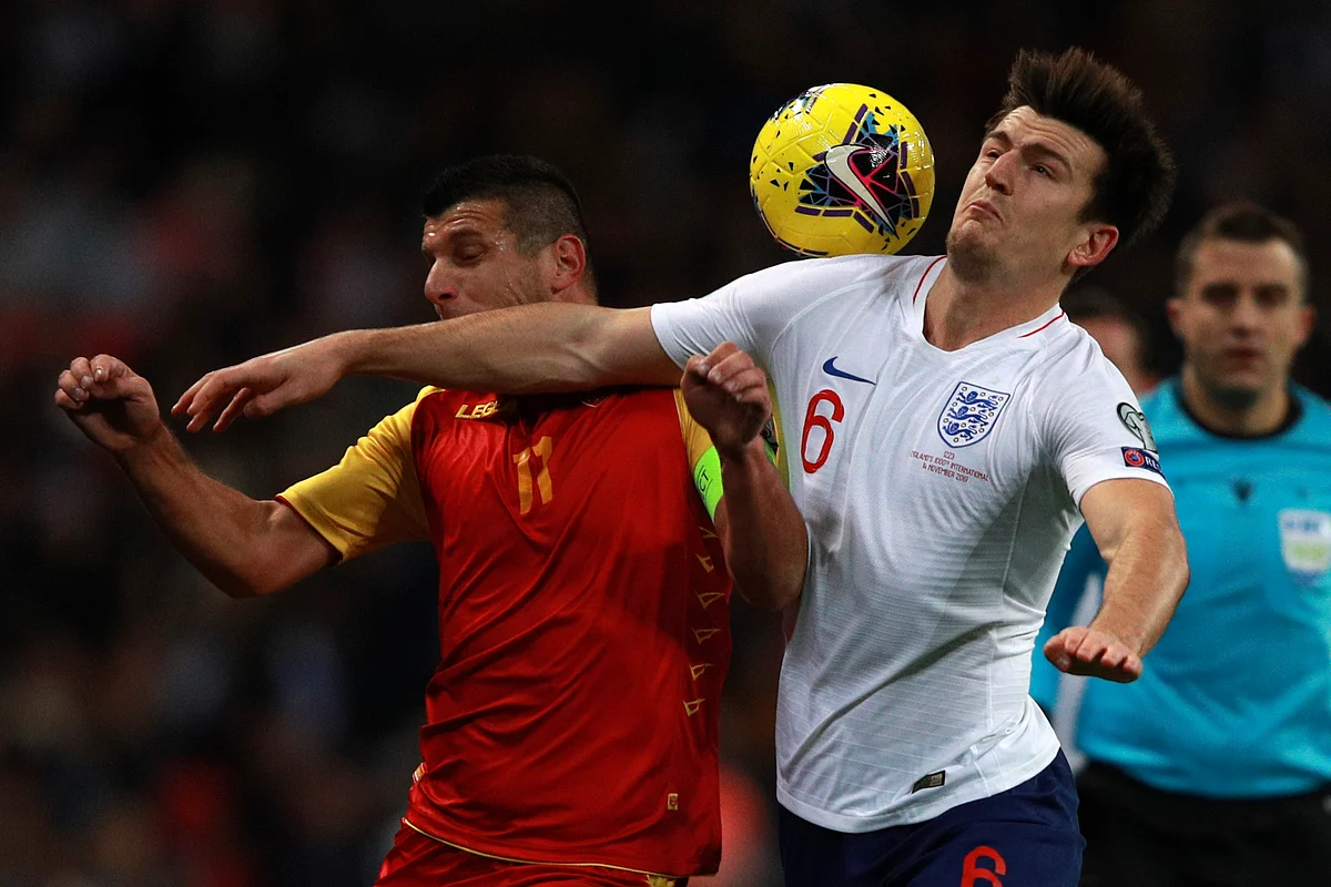 England’s Harry Maguire, right, and Montenegro’s Fatos Beciraj fight for the ball during the Euro 2020 group A qualifying football match between England and Montenegro at Wembley stadium in London.