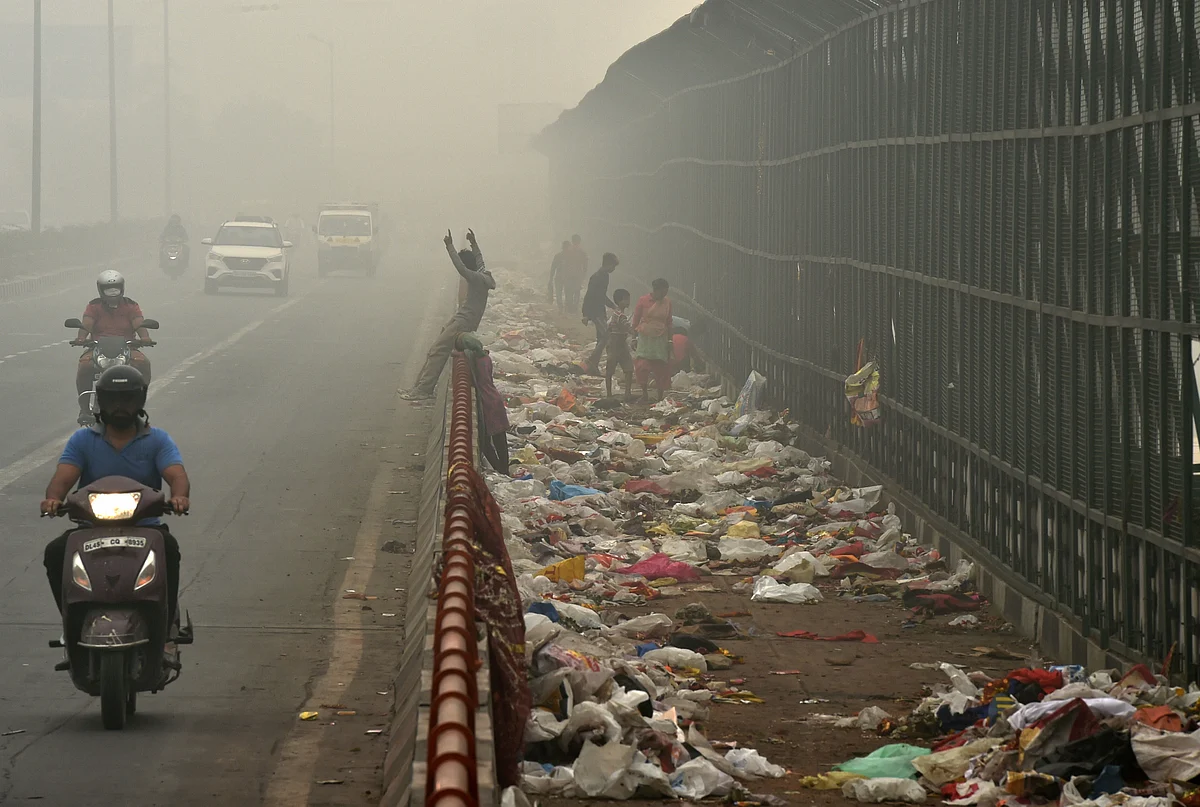 Plastic bags scattered on a pavement along Geeta Colony Setu over the River Yamuna. 