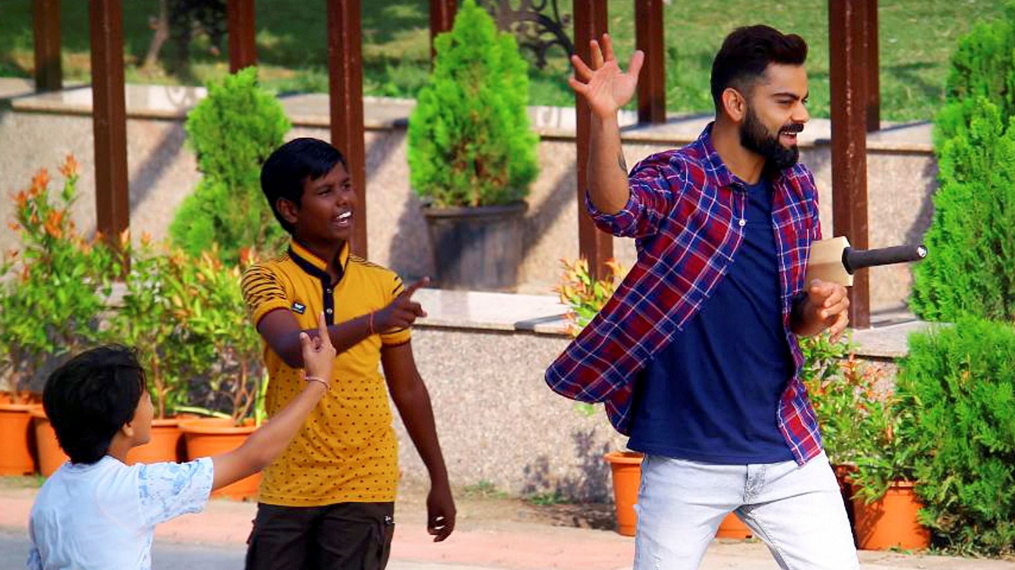 Indian captain Virat Kohli played gully (street) cricket with children during a shoot in Indore.