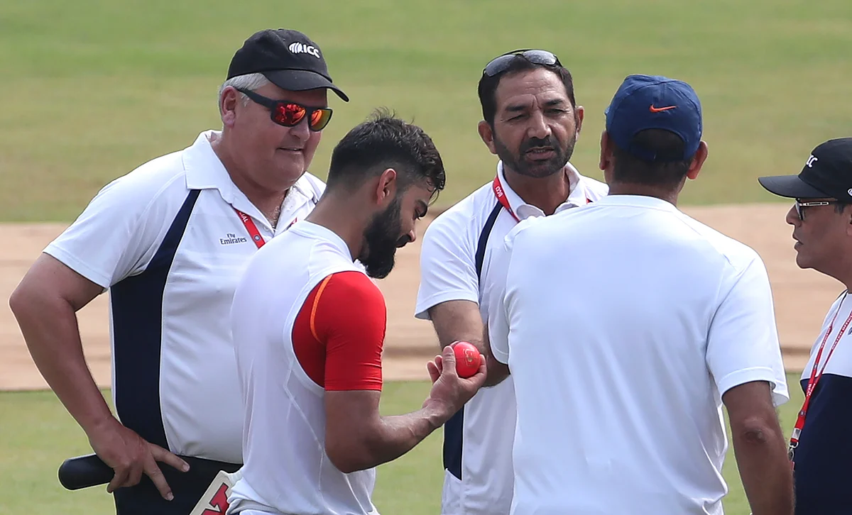 India’s captain Virat Kohli, second left, checks out the new pink ball as he interacts with umpires.