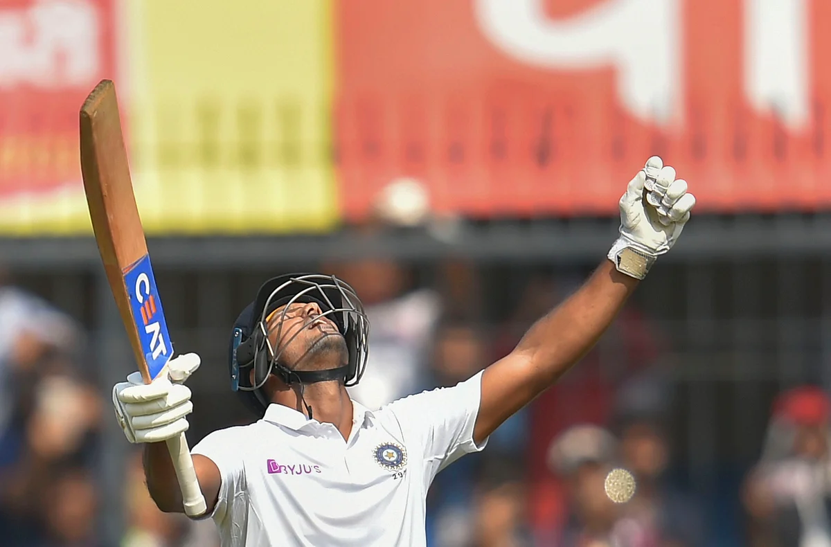 Indian batsman Mayank Agarwal holds up his bat as he reacts after scoring a century on the second day the first cricket test match against Bangladesh, in Indore, Friday, 15 November, 2019.