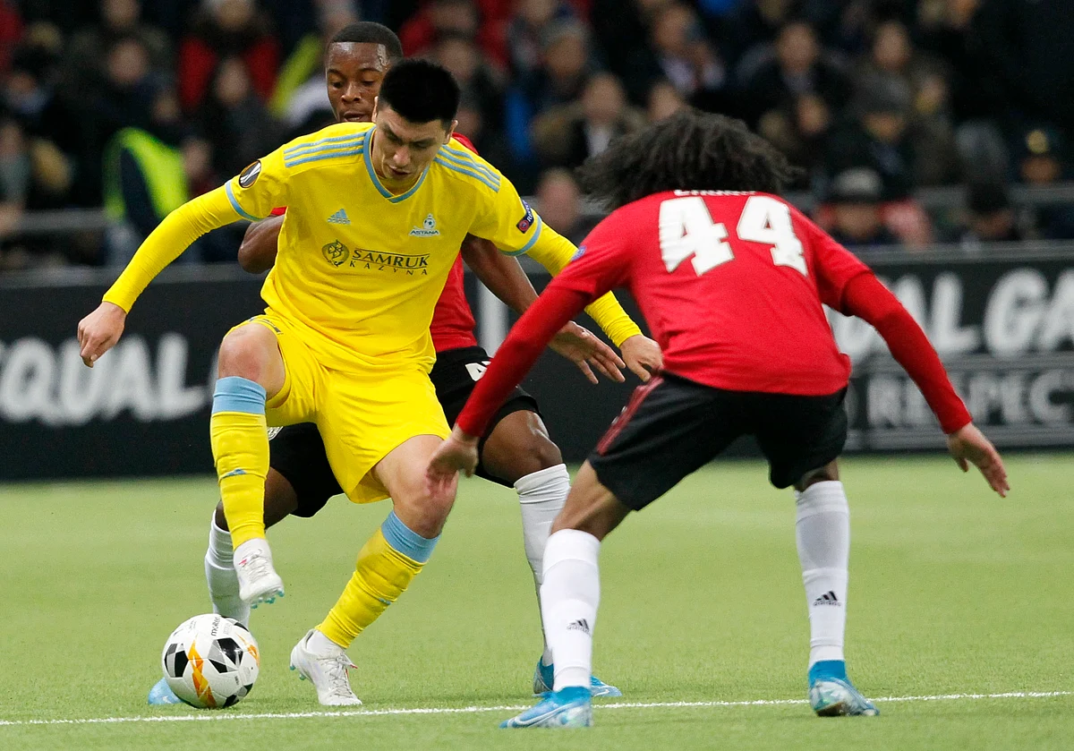 Astana’s Abzal Beisebekov and Manchester United’s Tahith Chong challenge for the ball in Kazakhstan on Thursday.