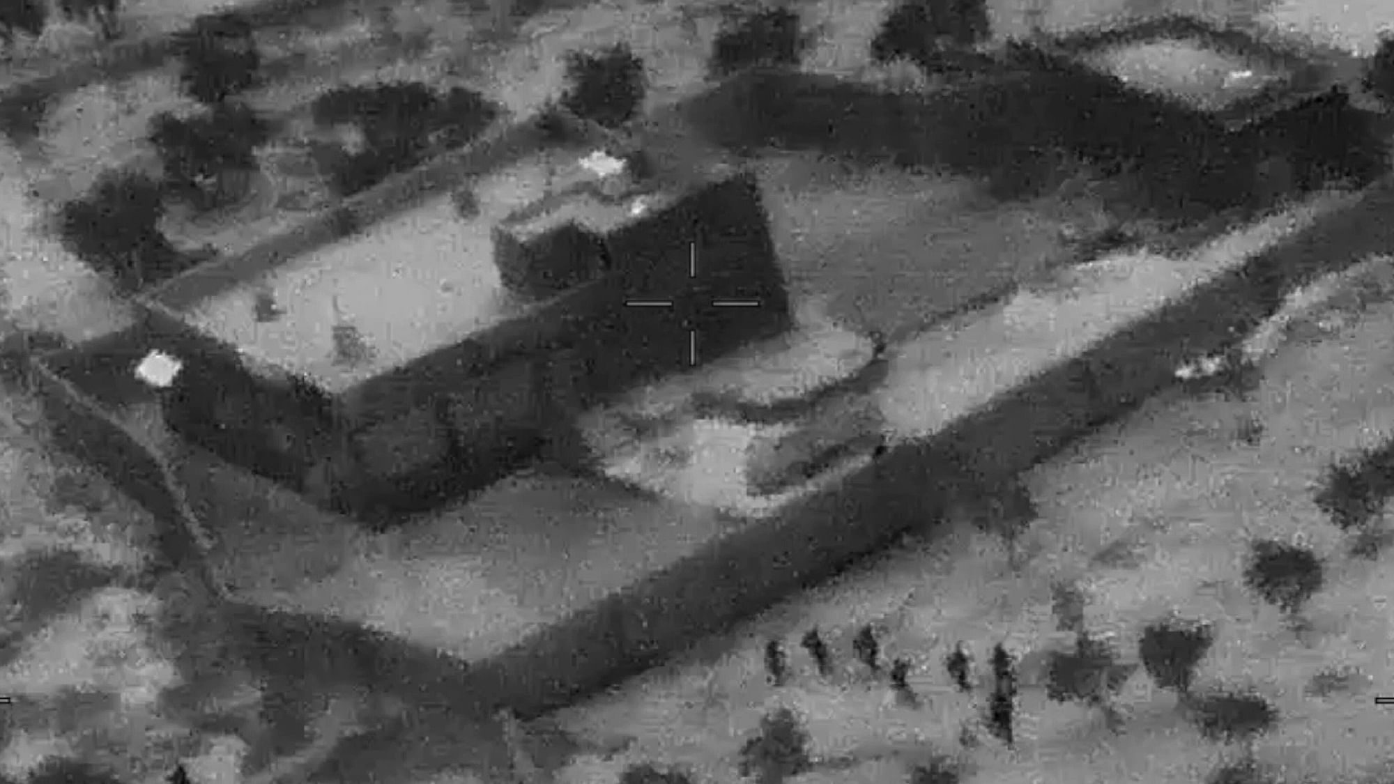 US Special Forces, figures at lower right, moving toward compound of Islamic State leader Abu Bakr al-Baghdadi. 