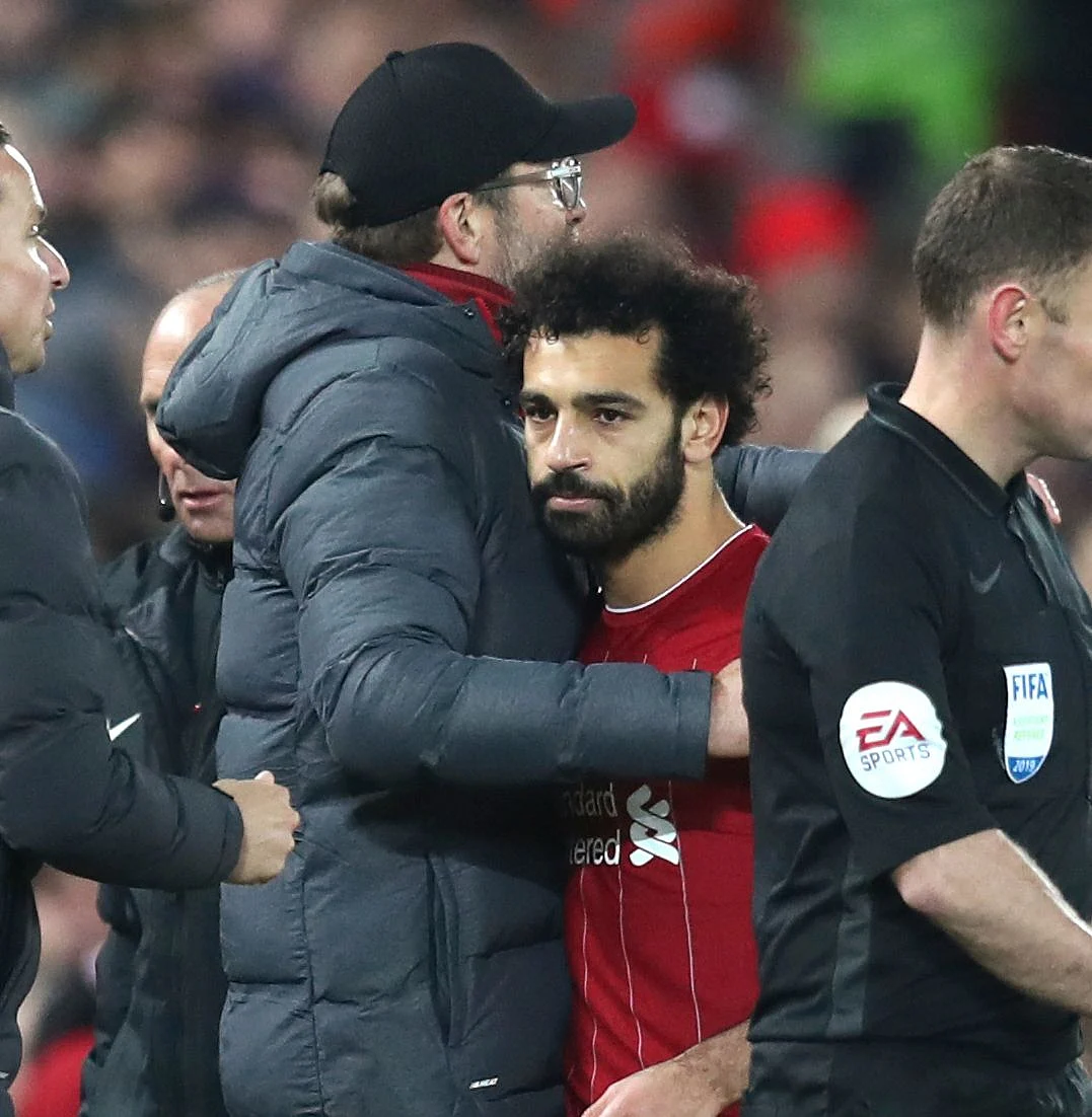 Liverpool’s manager Jurgen Klopp hugs with Liverpool’s Mohamed Salah as he leaves the field of play during the English Premier League soccer match between Liverpool and Manchester City at Anfield stadium in Liverpool, England, Sunday, Nov. 10, 2019.