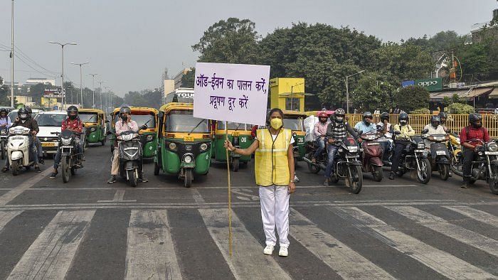 A Civil Defence vounteer displays placard asking people to abide by odd-even scheme. Image used for representational purposes.