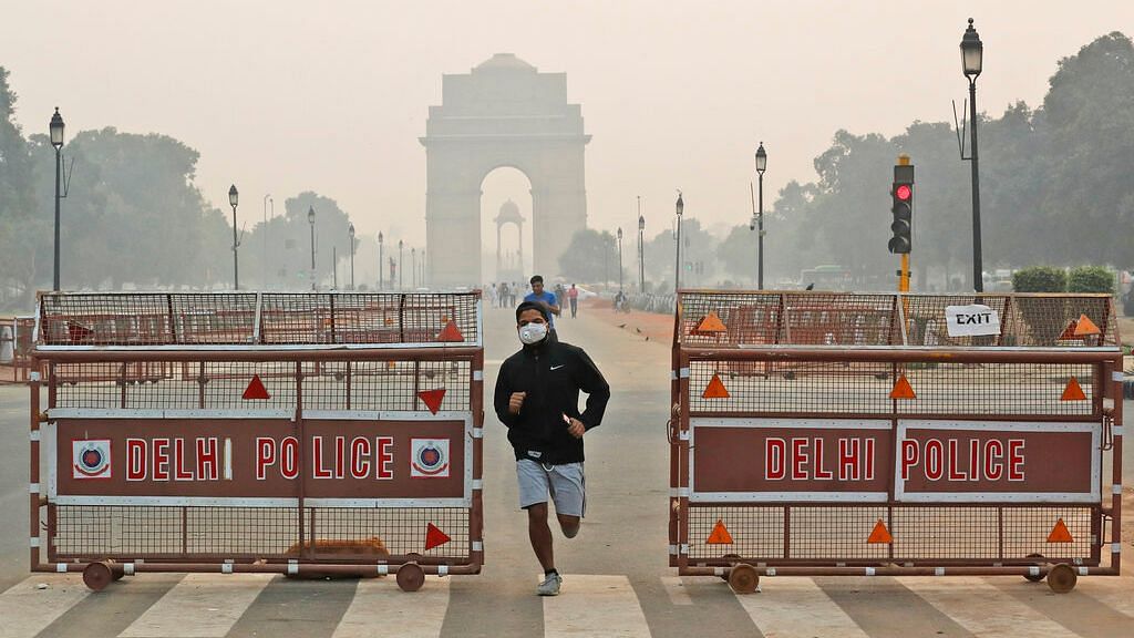 A jogger wears a pollution mask early morning amidst light smog in New Delhi. The national capital’s air quality dropped to the season’s worst on the morning after  Diwali.&nbsp;