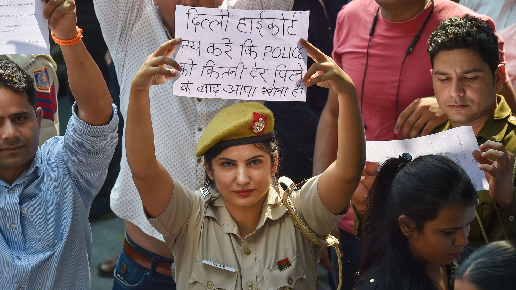 A Delhi Police personnel displays a placard during a protest on 5 November against the alleged repeated incidents of alleged violence against the police by lawyers.&nbsp;